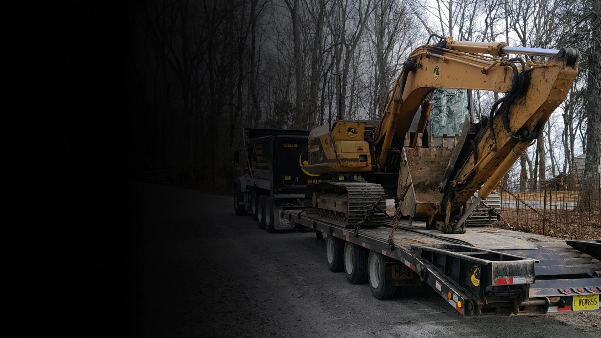 excavator being hauld hero